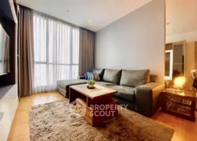 Modern living room with cozy sofa and large window in stylish apartment.