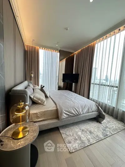 Luxurious bedroom with panoramic city view and modern decor in high-rise apartment.