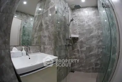 Modern bathroom with glass shower and sleek marble tiles