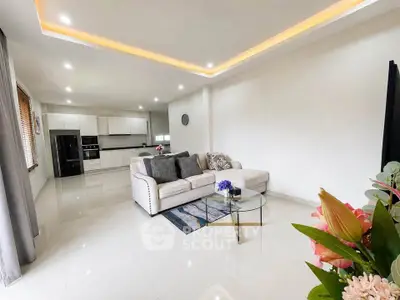 Spacious modern living room with open kitchen and elegant decor