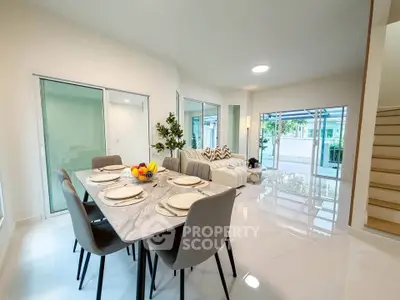 Spacious modern living and dining area with elegant decor and large windows.