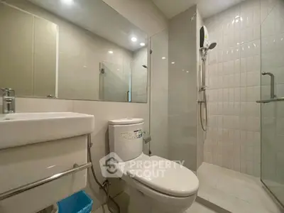 Modern bathroom with sleek fixtures and glass shower enclosure