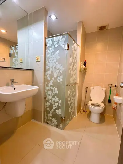 Modern bathroom with floral glass shower and sleek fixtures