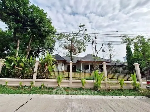 Charming suburban house with lush garden and modern fence