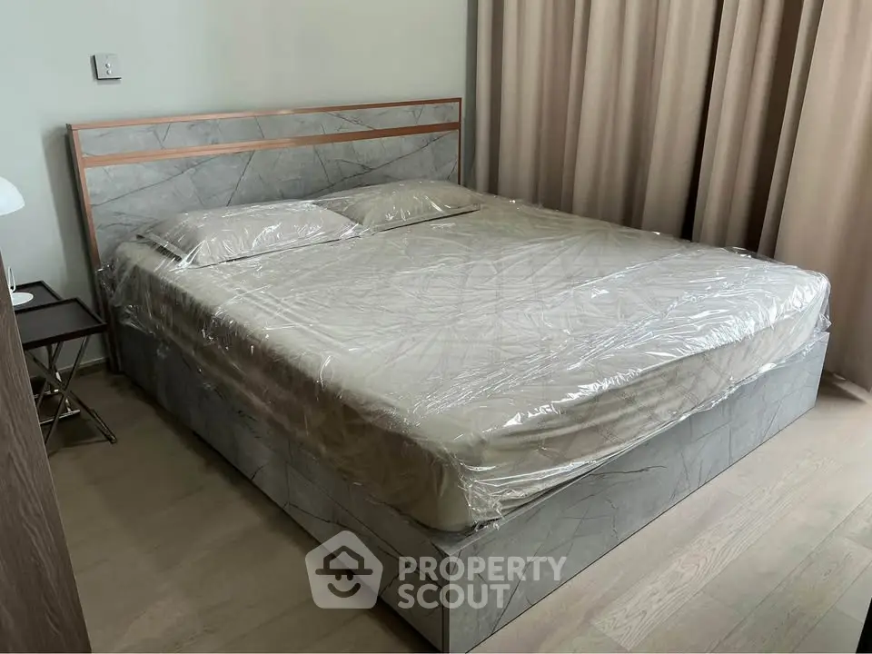 Modern bedroom with stylish bed and elegant curtains, perfect for a cozy retreat.