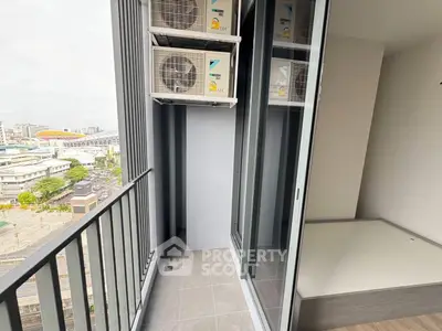 Modern apartment balcony with city view and air conditioning units