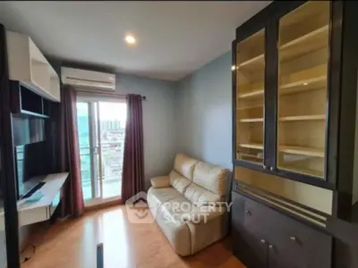 Cozy living room with modern furniture and city view balcony access.