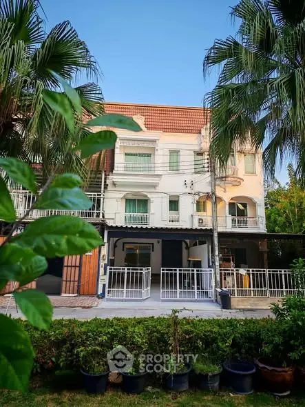 Charming townhouse with lush greenery and classic architecture, perfect for serene living.