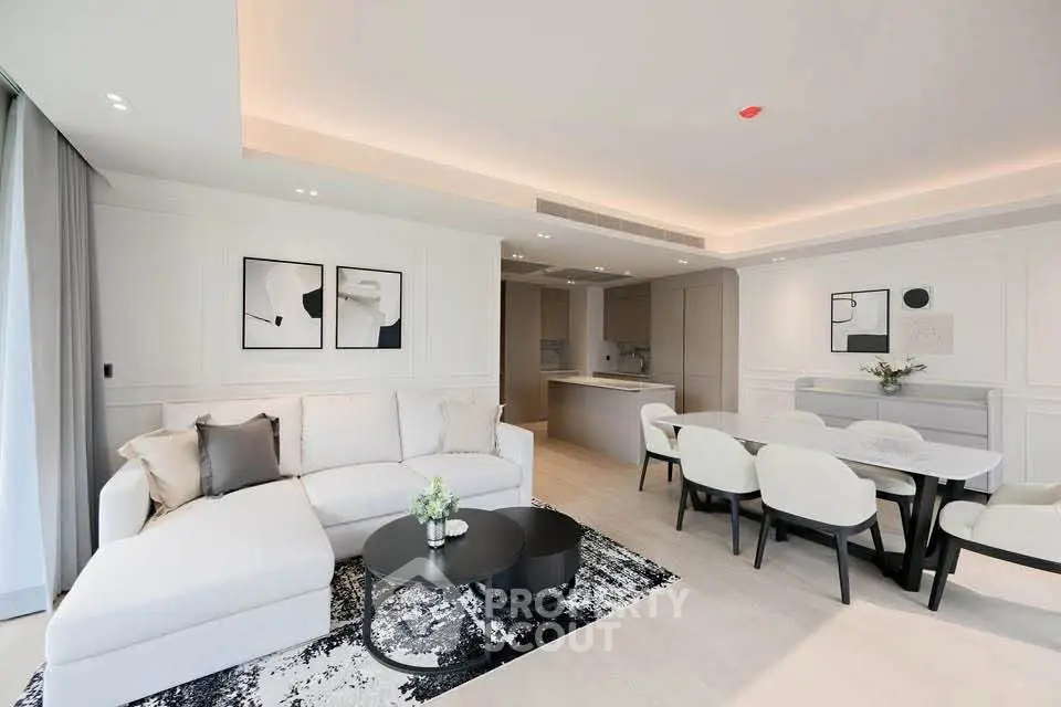 Luxurious modern living room with open kitchen and elegant dining area