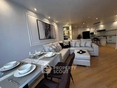 Spacious modern living room with elegant dining area and open kitchen layout.
