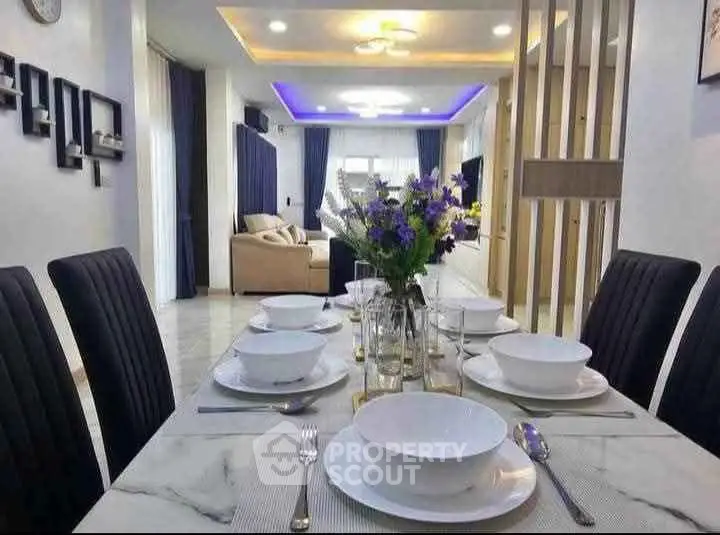Elegant dining area with modern decor and ambient lighting in a stylish home.