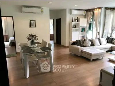 Spacious modern living room with elegant dining area and cozy sofa, perfect for family gatherings.