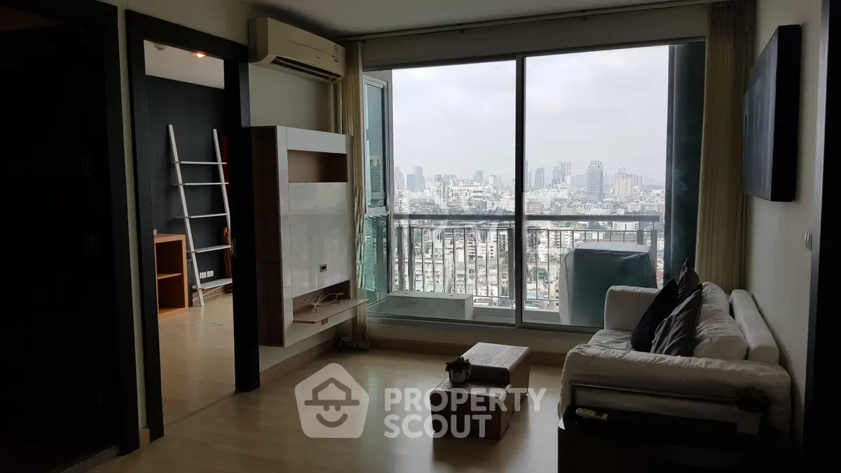Spacious living room with city view and modern decor in high-rise apartment.