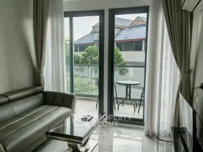 Modern living room with balcony view and sleek furniture