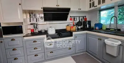 Modern kitchen with sleek cabinetry and appliances, featuring a gas stove and ample counter space.