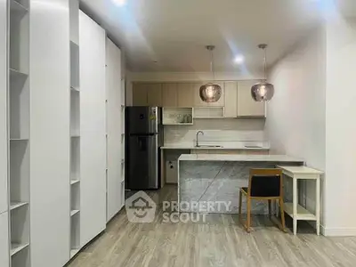 Modern kitchen with sleek cabinetry and marble island in stylish apartment