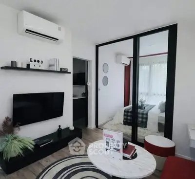 Modern living room with stylish decor and mirrored wardrobe in a cozy apartment.