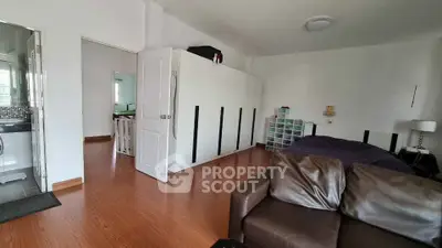 Spacious bedroom with modern decor and wooden flooring