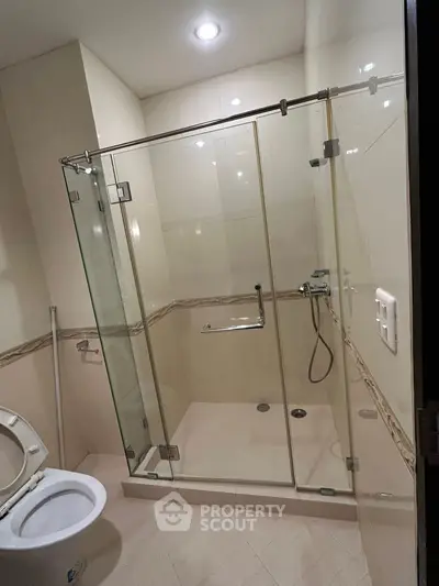 Modern bathroom with glass shower enclosure and sleek fixtures