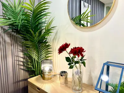 Stylish interior with elegant decor, mirror, and vibrant plants enhancing modern living space.
