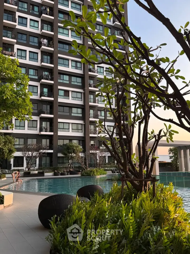 Luxurious apartment building with stunning pool and lush greenery