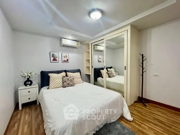 Cozy bedroom with mirrored closet and modern decor