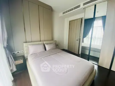 Modern bedroom with sleek design and mirrored wardrobe in a luxury apartment