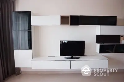 Modern living room with sleek wall-mounted entertainment unit and TV