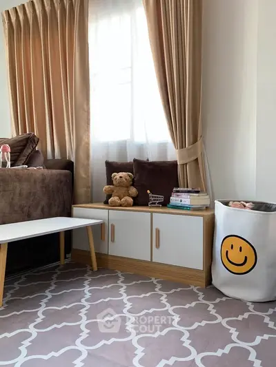 Cozy living room with plush sofa, elegant curtains, and stylish storage solutions.