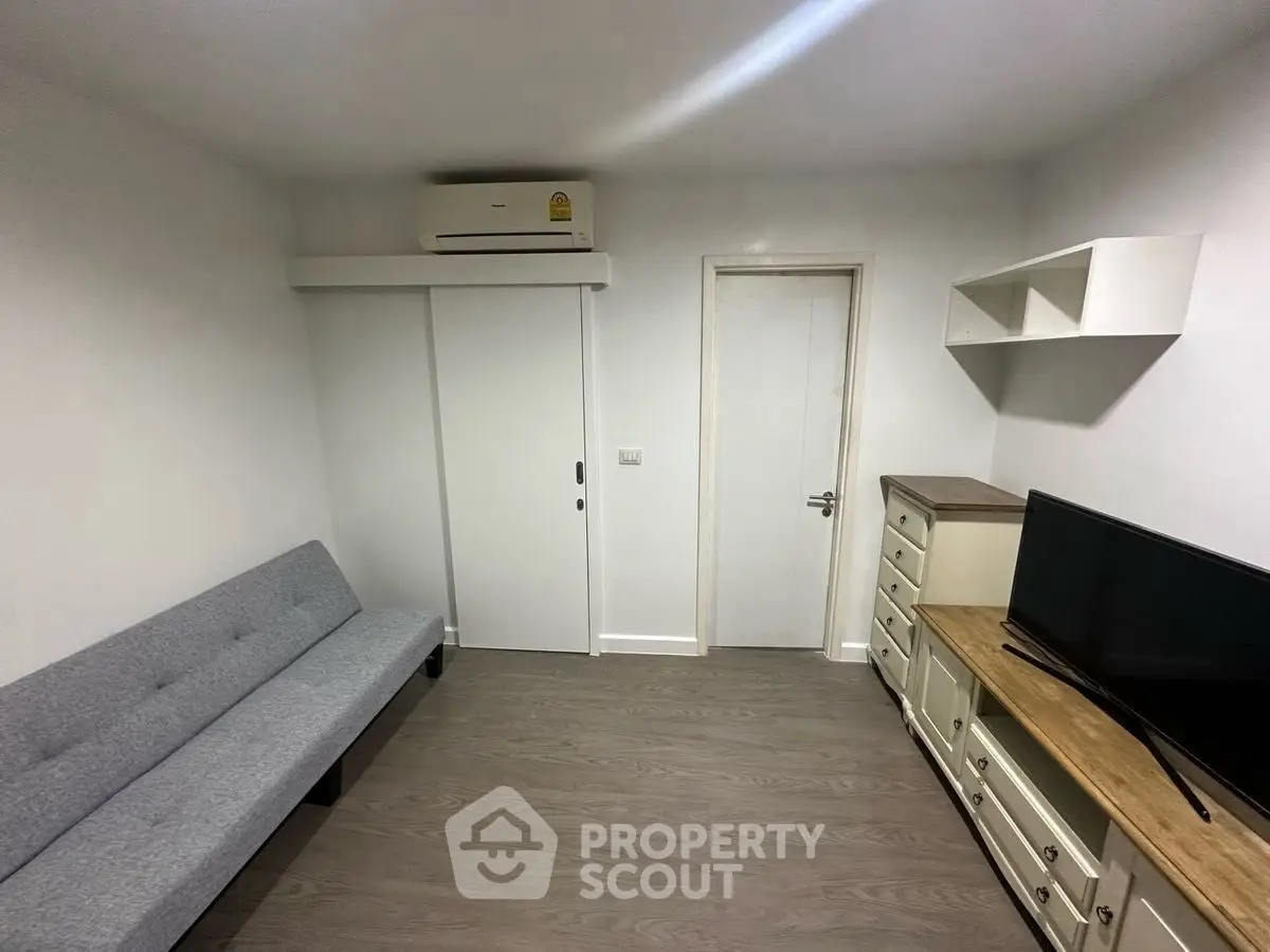 Modern living room with sleek furniture and air conditioning, perfect for cozy living.