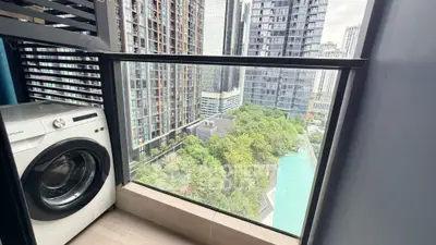 High-rise balcony with washing machine and stunning cityscape view