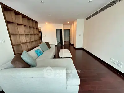 Spacious modern living room with elegant wooden flooring and stylish sofa.