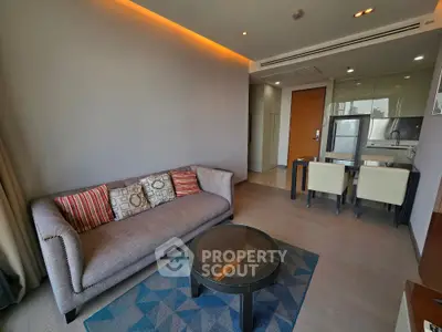 Modern living room with stylish sofa and dining area in open layout apartment