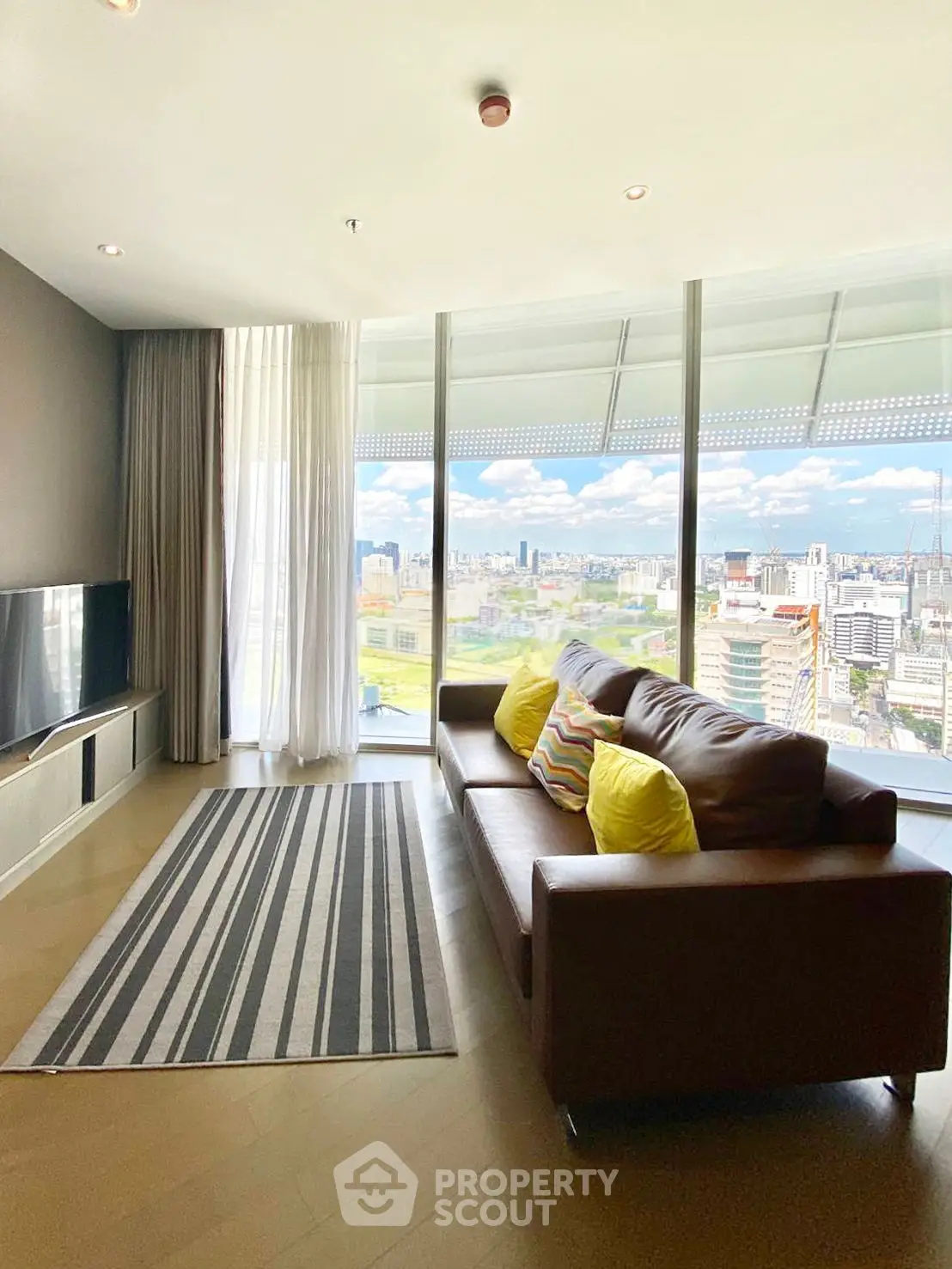 Spacious living room with panoramic city view and modern decor