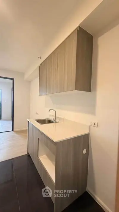 Modern kitchen with sleek cabinetry and minimalist design in a contemporary apartment.