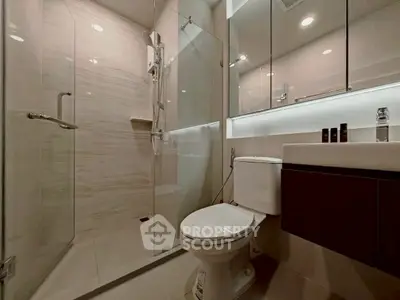 Modern bathroom with glass shower and sleek fixtures