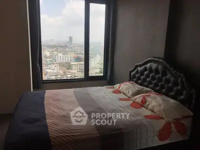 Cozy bedroom with stunning city view from large window, featuring elegant headboard and modern decor.