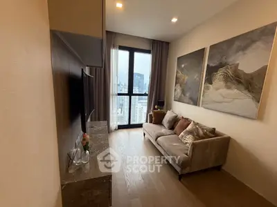 Stylish living room with city view, modern decor, and cozy seating in a high-rise apartment.