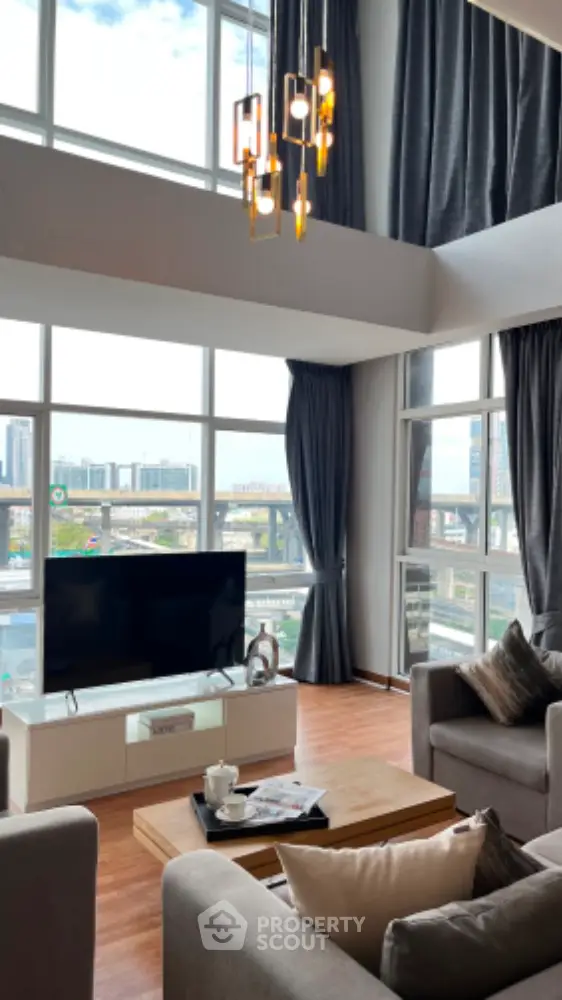 Luxurious high-ceiling living room with panoramic city view and modern decor