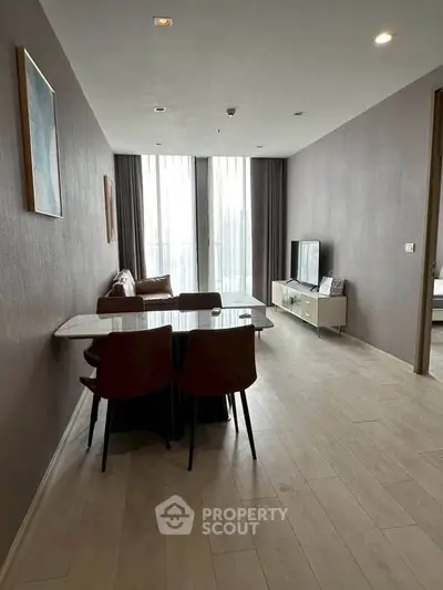 Modern living room with sleek furniture and large windows for natural light.