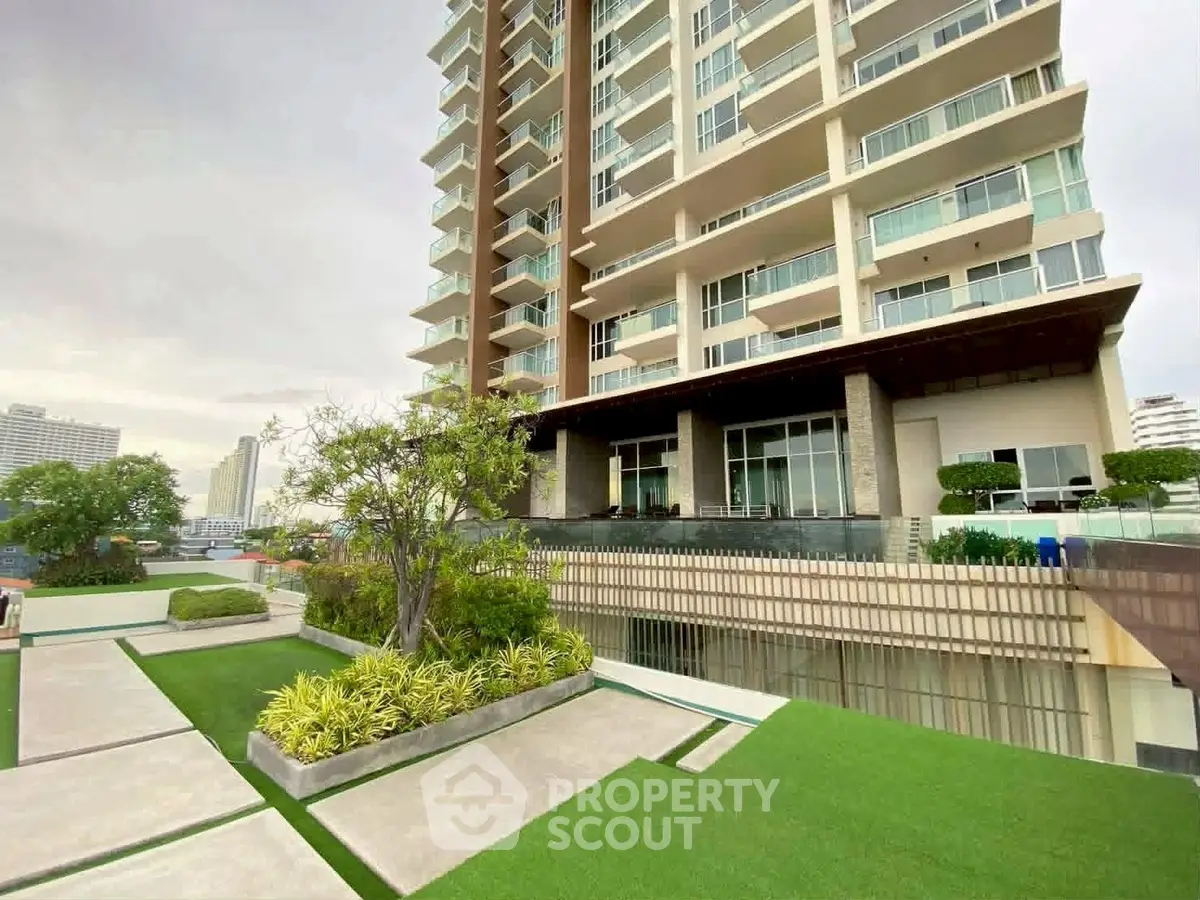 Luxurious high-rise building with landscaped garden and modern architecture.