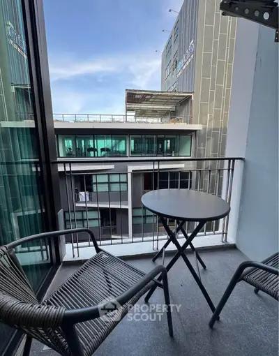 Modern balcony with stylish furniture and city view