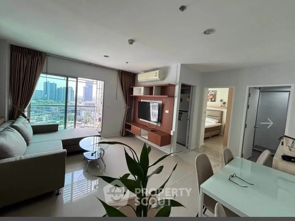 Spacious modern living room with city view, open layout, and elegant furnishings in a high-rise apartment.