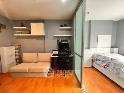 Modern bedroom with study area, featuring sleek furniture and wooden flooring, ideal for urban living.