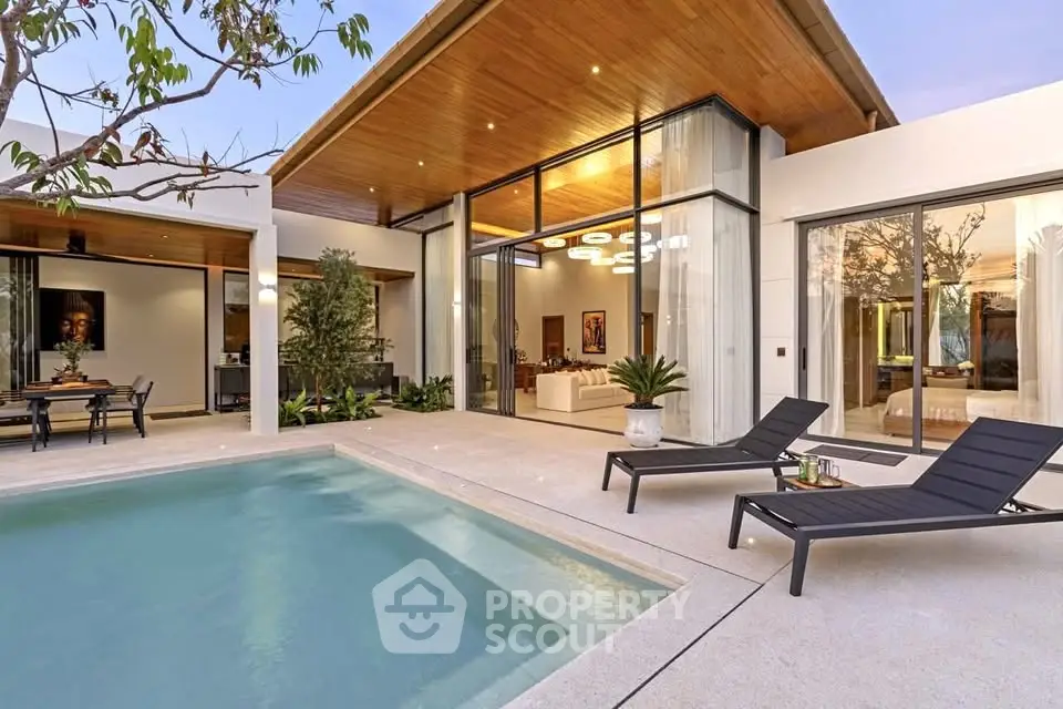 Luxurious modern villa with private pool and stylish outdoor lounge area.