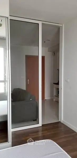 Modern apartment interior with sliding glass doors and wooden flooring