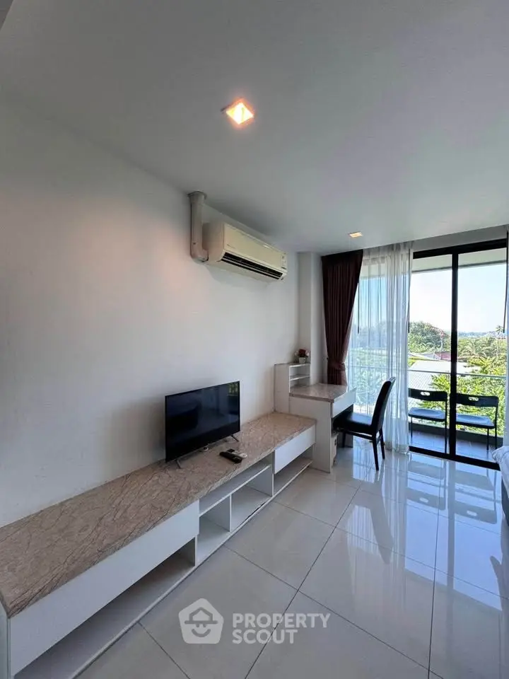 Modern living room with sleek furniture and large windows offering a scenic view, perfect for relaxation.