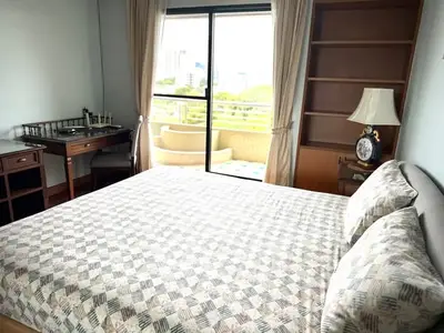 Spacious bedroom with balcony access and elegant decor