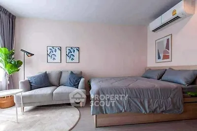 Cozy bedroom with modern decor and comfortable seating area