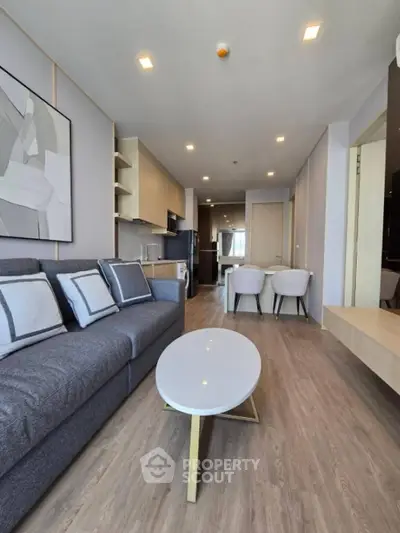 Modern living room with stylish decor and open kitchen layout in a contemporary apartment.
